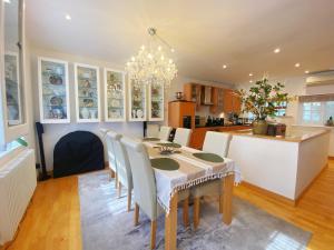 a kitchen and dining room with a table and chairs at Luxury Belgrave Square Private Mews TownHouse in London