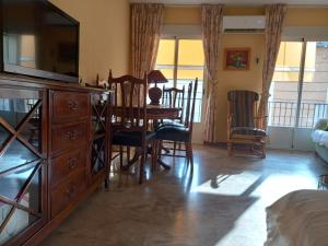 a living room with a dining table and a dresser at Alojamiento Vacacional Inma in Cazorla
