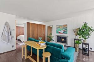 a living room with a blue couch and a table at 1BR 1BA Emerald Garden Bliss Seattle Location in Seattle