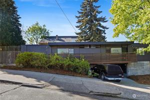 a black truck parked in front of a house at 1BR 1BA Emerald Garden Bliss Seattle Location in Seattle