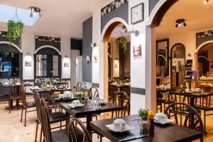 a restaurant with tables and chairs in a room at Grand Hôtel De Paris in Paris +18 photos