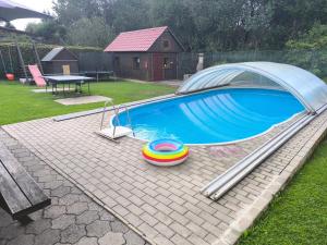 a large swimming pool with a metalosureermott at Penzion Dajan in Strmilov