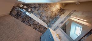 an overhead view of a bathroom with a staircase at Les Grands Gîtes de Cancale, gîtes de charme avec jacuzzi in La Coudre