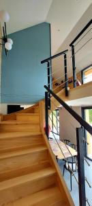 a staircase in a building with wooden floors and a blue wall at Les Grands Gîtes de Cancale, gîtes de charme avec jacuzzi in La Coudre