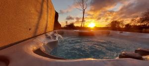 a hot tub with a water fountain in the snow at Les Grands Gîtes de Cancale, gîtes de charme avec jacuzzi in La Coudre