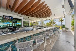 a bar at the beach with chairs and tables at Catalina by the Beach 6 in Pompano Beach