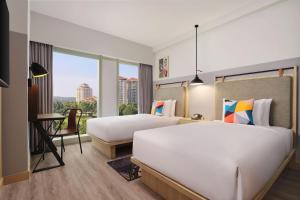 Ein Bett oder Betten in einem Zimmer der Unterkunft Moxy Putrajaya
