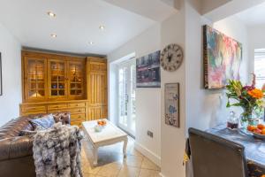 a living room with a couch and a table at Traditional English 4 bedroom home in Greenwich in Plumstead