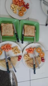 a set of three plates of food with forks and knives at Rice field guest house in Kelimutu