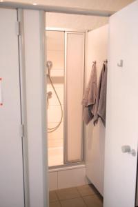 a bathroom with a shower and a glass door at Urban Loft in Vibrant Kreuzkölln in Berlin