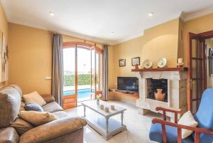 a living room with a couch and a fireplace at Villa Joaquina in Port d'Addaia