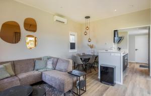 a living room with a couch and a table at 2 Bedroom Amazing Home In Voorthuizen in Voorthuizen