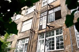 an old brick building with white windows at Urban Loft in Vibrant Kreuzkölln in Berlin