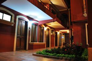 a hallway of a building with red walls at Apartotel Don Luis in Bajo de las Labores