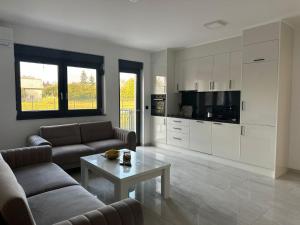 a living room with a couch and a coffee table at BLUE SKY Apartments in Sarajevo