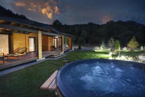 a large hot tub in the yard of a house at Casa Twins - Slanic Moldova in Slănic-Moldova