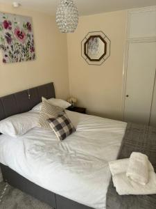 a bed with white sheets and pillows in a bedroom at The smithy in Hodnet