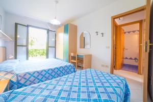 a hotel room with two beds and a window at Residence Porto Sole in Cavallino-Treporti +73 photos