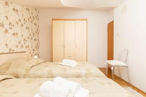 Postel nebo postele na pokoji v ubytování Apartments Emma