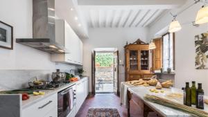 a kitchen with white cabinets and a counter with food on it at Villa cerreta in Massa e Cozzile