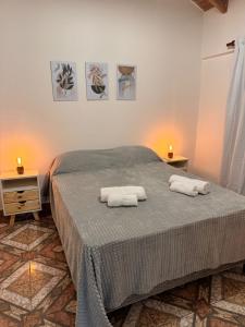 a bedroom with a bed with two towels on it at Apartamentos Mara - 100m de Termas in Federación