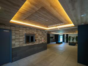 an office lobby with a wooden ceiling and a hallway at Queen's Park 空港直通 新今宮駅 通天閣 新世界 in Osaka