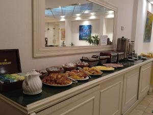 a buffet with many plates of food on a counter at ATLAS TOWER HOTEL in Buenos Aires