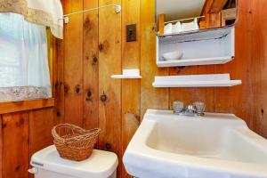 a bathroom with a white sink and a toilet at Evergreen in Northport