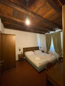 Postel nebo postele na pokoji v ubytování Cascina Belvedì
