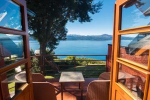 a view from the window of a house with a view of the water at Costa Brava Apart Hotel & Suites in San Carlos de Bariloche