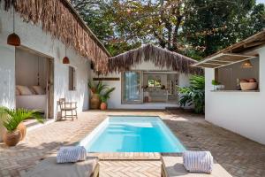 a swimming pool in the backyard of a house at Pousada Seis e Meia in Trancoso