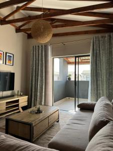 a living room with a couch and a coffee table at The Ridge in Rustenburg