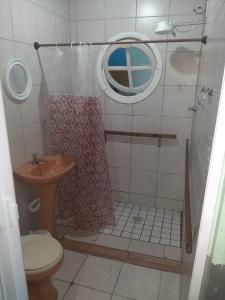 a bathroom with a shower with a toilet and a sink at Vivendas do Trabalhador in São Francisco do Sul
