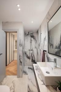 a bathroom with a sink and a mirror at Navona Apartment in Labin