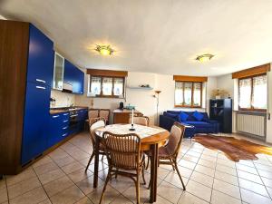 a kitchen and living room with a table and chairs at Stephanie Residence in Esino Lario