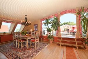 a dining room with a table and chairs in a room at Meerblick in Binz +6 photos