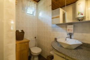 a bathroom with a sink and a toilet at Domki Letniskowe Kobyłocha in Kobyłocha