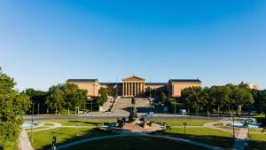 a building with a fountain in the middle of a park at Fairmount Art Museum Center City Suites in Philadelphia