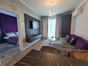 a living room with a couch and a bed at Residence Sole 5 by Wave - Apartament luxury 60mp cu terasa si vedere la mare, acces direct pe plaja OhiOhi Beach- Mamaia Nord - Restaurant, Parcare gratuita in Mamaia Sat/Năvodari