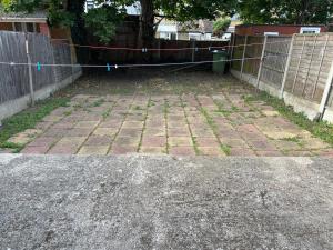 a patio with a fence and a gate with at EQU London in Ilford