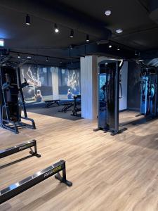 a gym with rows of treadmills and machines at Baltic Sands Apartment- 15 min Beach Free Parking Premium Letnica in Gdańsk