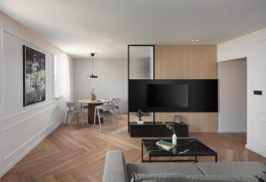 a living room with a couch and a table at Canova Apartment in Labin +9 photos