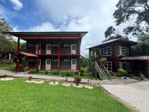 a large house with a yard in front of it at Hotel Bosque Verde Lodge in Monteverde Costa Rica