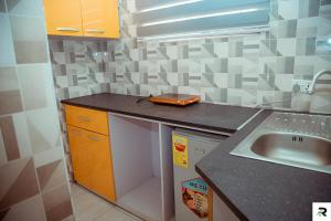 a kitchen with a sink and a counter top at Magic Apartments in Accra