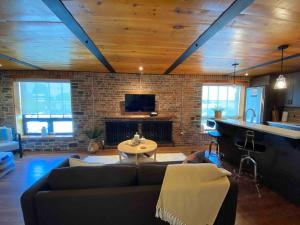 a living room with a couch and a fireplace at Cozy downtown studio getaway in Kingston