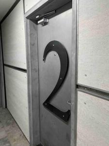 a metal door with a number on it at Cozy downtown studio getaway in Kingston