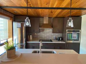 a kitchen with a sink and a counter with three lights at Cozy downtown studio getaway in Kingston +5 photos