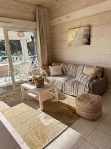 a living room with a couch and a table at Jolie Maison Cosy Vue Golfe de Saint Tropez in Gassin