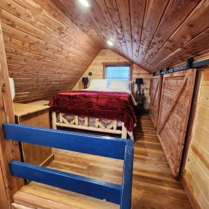 a bedroom in a log cabin with a bed in it at The Windstorm Cabin - Pet-friendly & a 2-person Jacuzzi hot tub! in Marshall