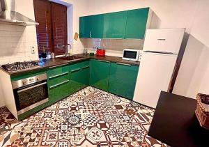 a kitchen with green cabinets and a tile floor at Casa curte interioara, centru in Cluj-Napoca